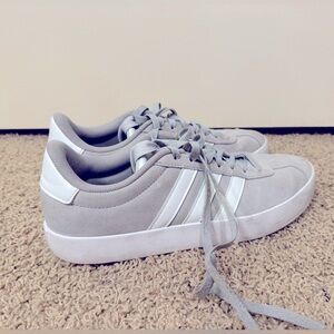 Gray low adidas tie up kicks.